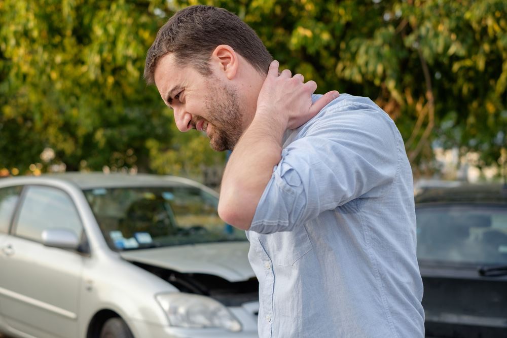 Man touching his neck after a rear-end collision