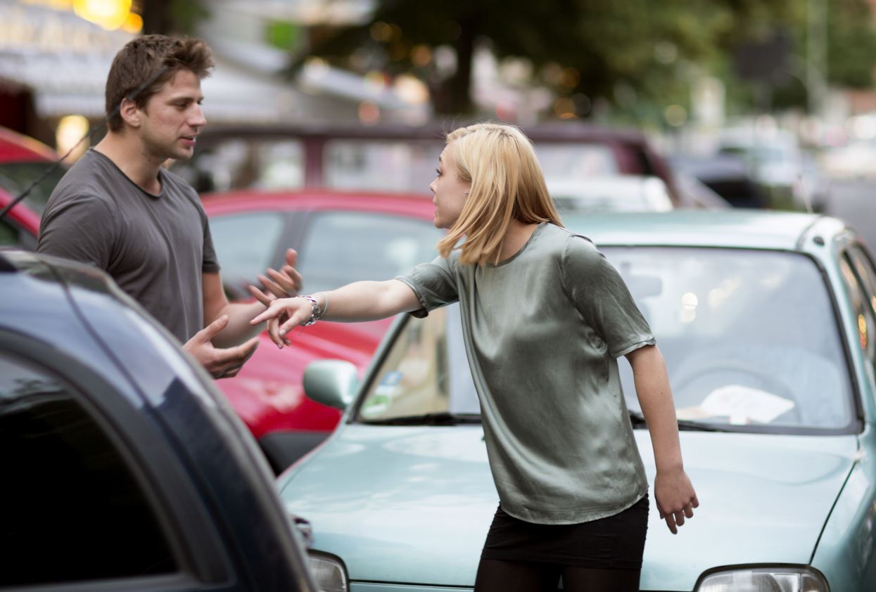 man and woman arguing after a rear-end accident